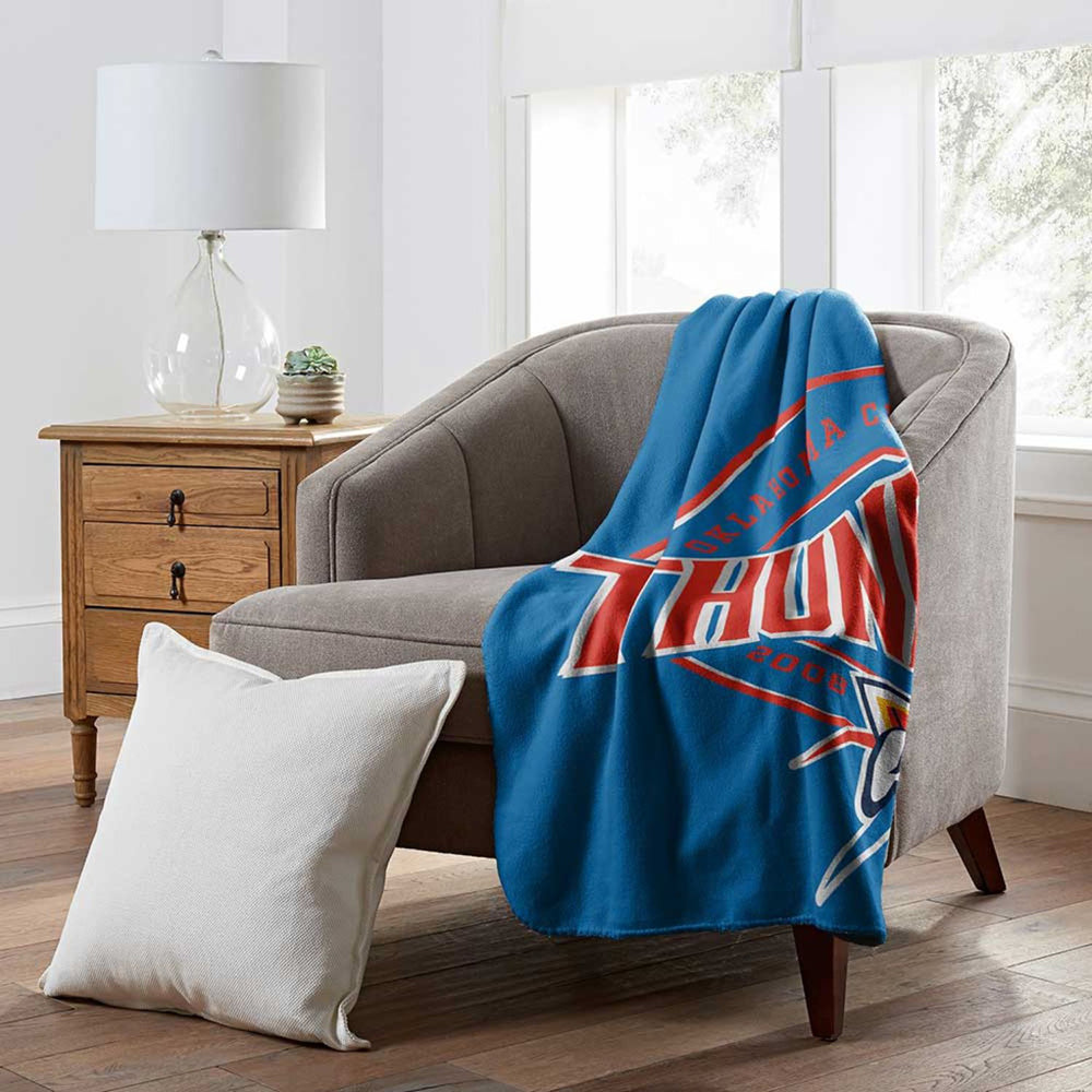 OKC THUNDER FLEECE 50" X 60" CAMPAIGN THROW BLANKET On Chair
