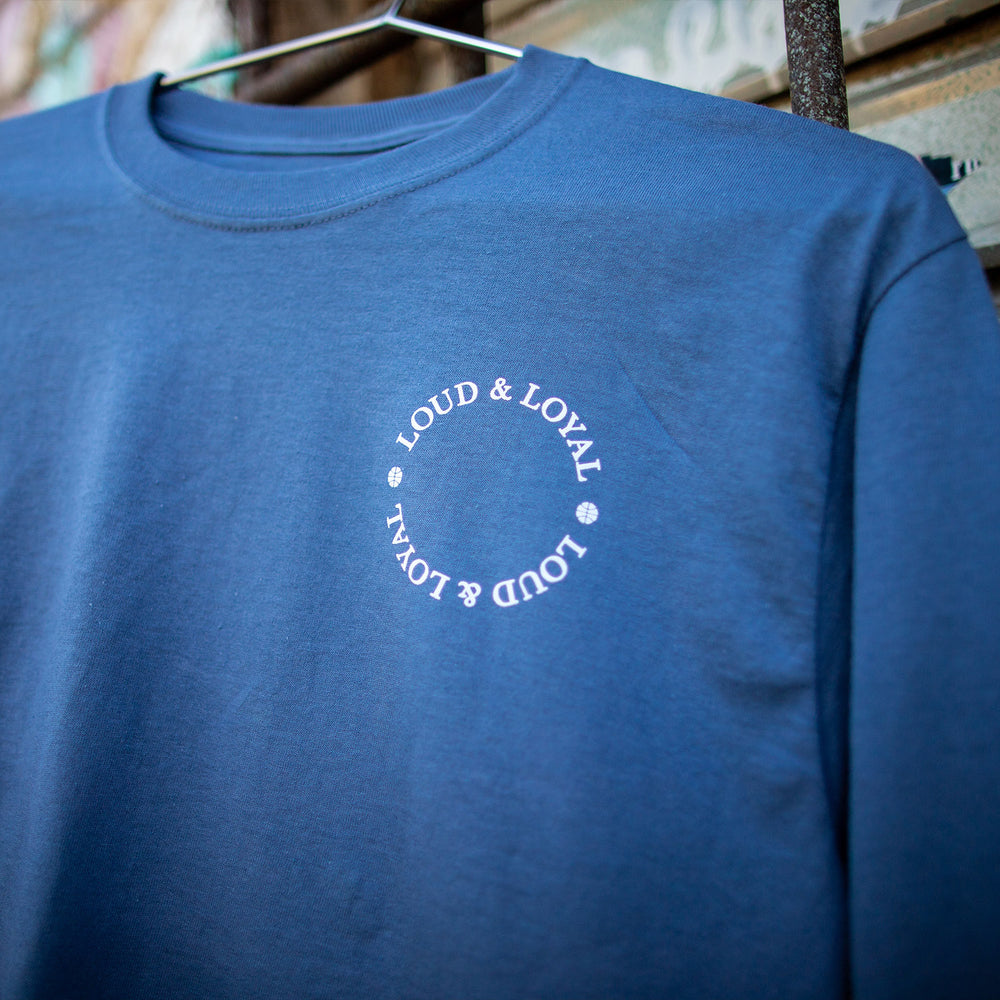 LOUD & LOYAL x OKLAHOMA CITY THUNDER "CUT FROM A DIFFERENT CLOTH" LONG SLEEVE IN BLUE - LIFESTYLE IMAGE OF FRONT LOGO