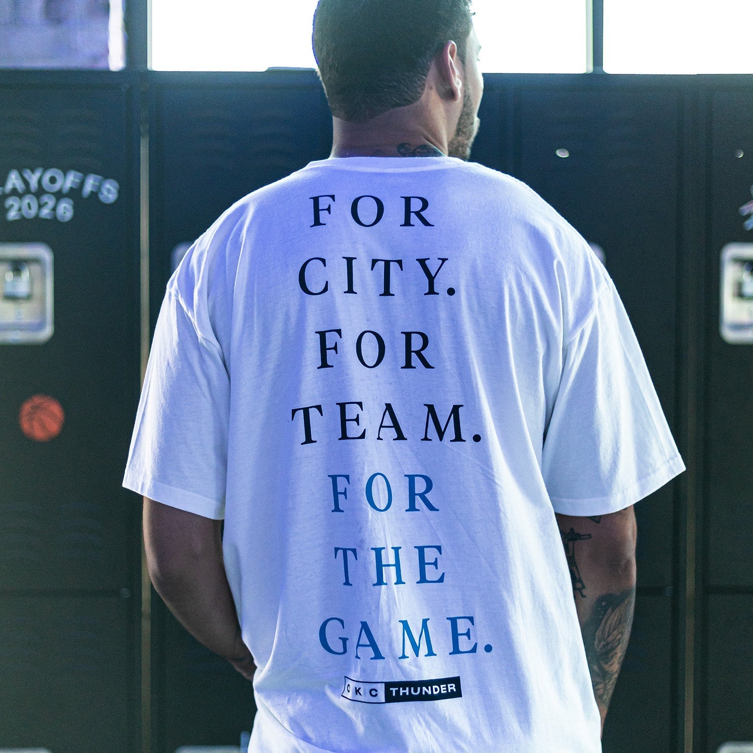 man standing with his back to us with the text that says: for city. for team. for the game