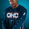 Model Wearing 2025-26 CITY EDITION OKC THUNDER NIKE LONG SLEEVE PREGAME T-SHIRT