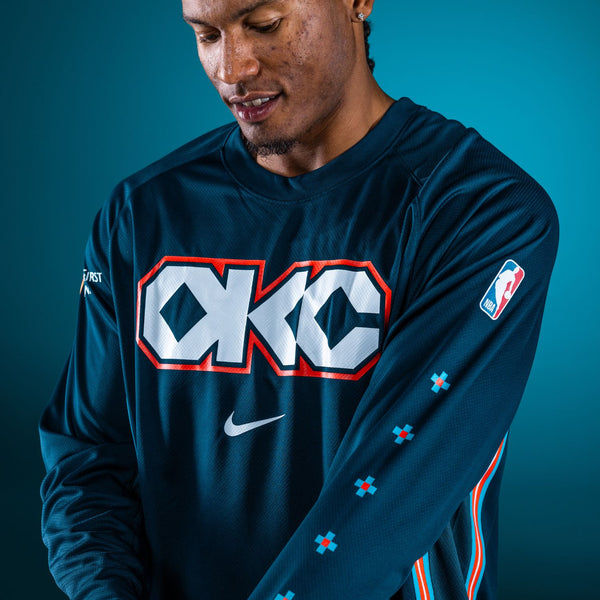 Model Wearing 2025-26 CITY EDITION OKC THUNDER NIKE LONG SLEEVE PREGAME T-SHIRT