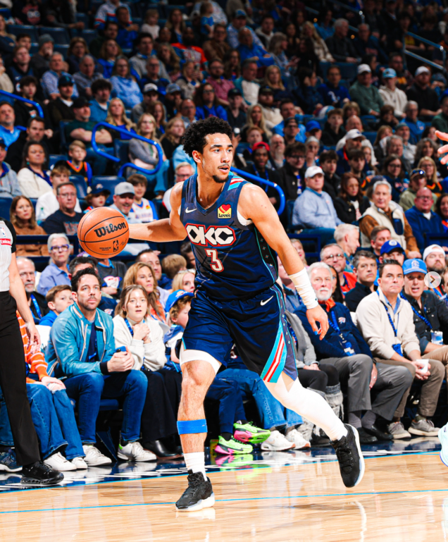 Basketball player in action during a game with a crowd in the background