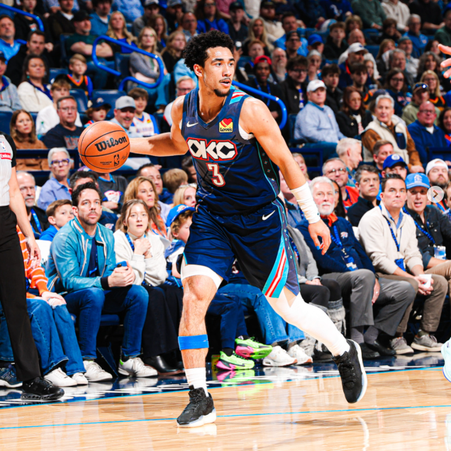 Basketball player in action during a game with a crowd in the background