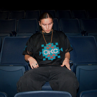 Model wearing OKC Thunder X Round21 Native Heritage Mesh Top